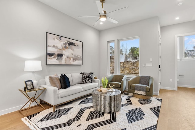 living area featuring recessed lighting, baseboards, light wood-style floors, and a ceiling fan