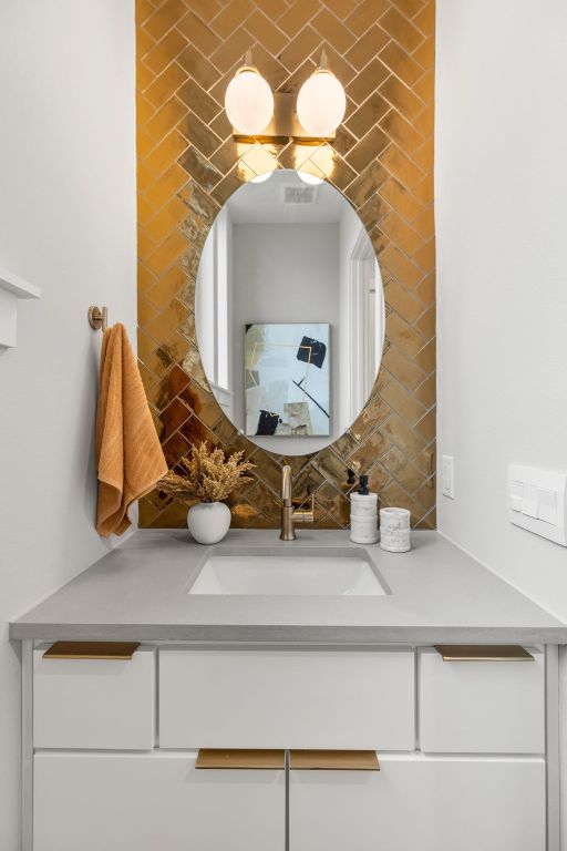 900 S 2nd St Unit 23, Austin, TX 78704 - bathroom featuring vanity and tasteful backsplash