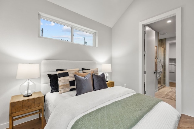 bedroom with wood finished floors, baseboards, and vaulted ceiling