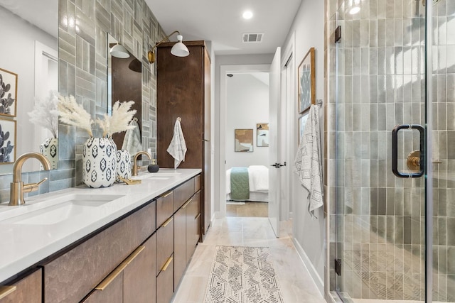 900 S 2nd St Unit 23, Austin, TX 78704 - ensuite bathroom featuring double vanity, a shower stall, baseboards, tasteful backsplash, and recessed lighting