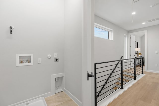 900 S 2nd St Unit 23, Austin, TX 78704 - laundry area with hookup for an electric dryer, gas dryer hookup, washer hookup, light wood finished floors, and attic access