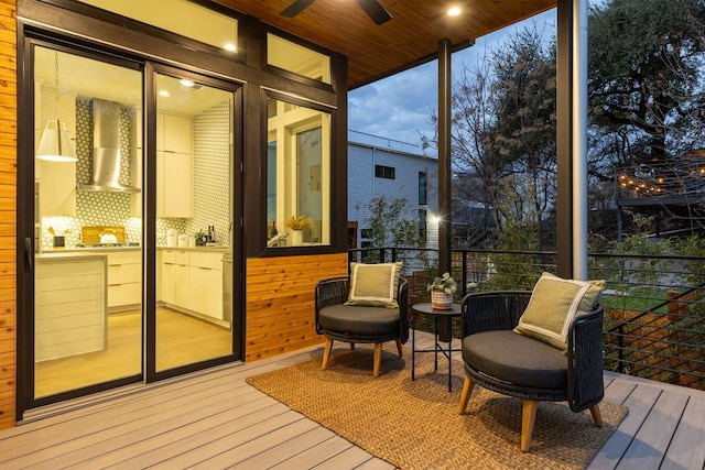 sunroom featuring wooden ceiling and a ceiling fan