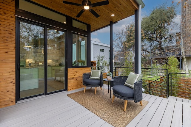 wooden terrace featuring a ceiling fan