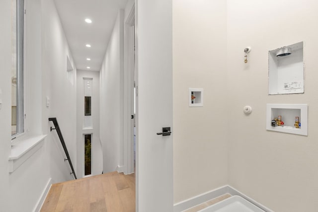 interior space featuring recessed lighting, an upstairs landing, and wood finished floors