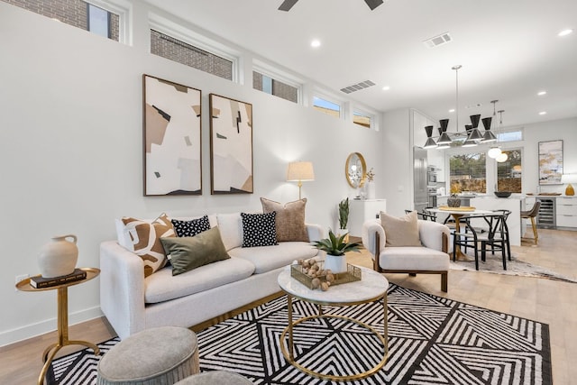 900 S 2nd St Unit 22, Austin, TX 78704 - living area with healthy amount of natural light, light wood-style flooring, recessed lighting, beverage cooler, and a chandelier