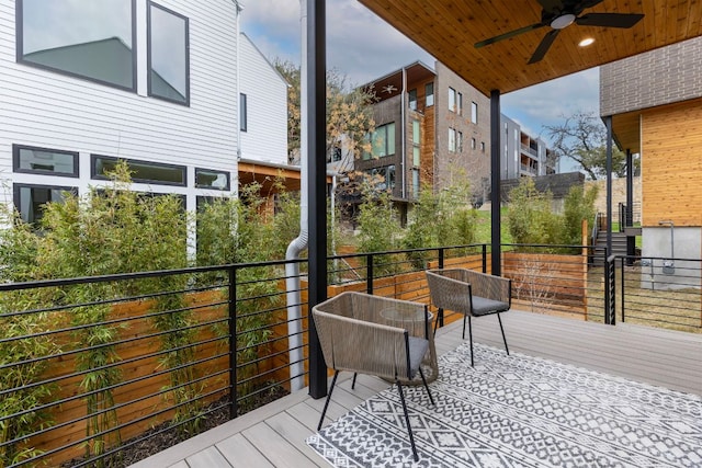 wooden deck featuring ceiling fan