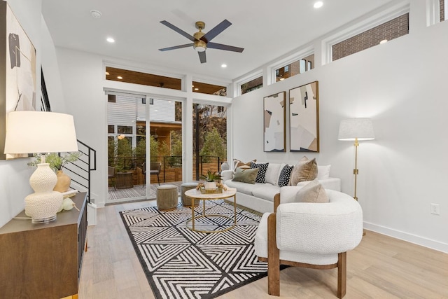 living room with light wood finished floors, recessed lighting, baseboards, and ceiling fan