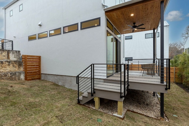 exterior space featuring stairway, a yard, and a ceiling fan