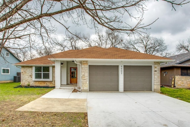 view of front facade featuring a shingled roof, a front yard, central AC unit, a garage, and stone siding