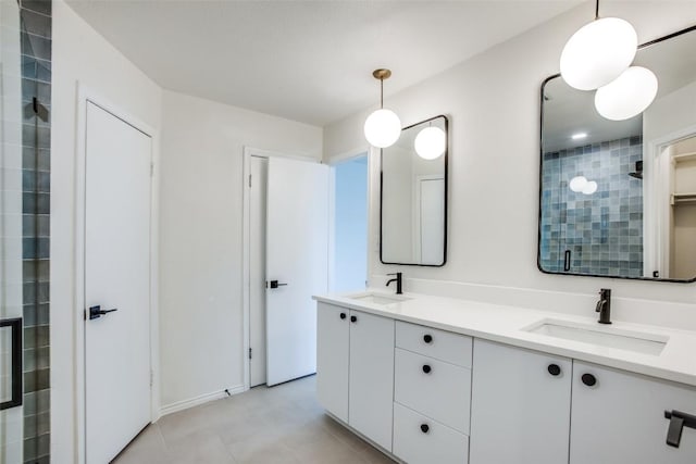 full bath featuring double vanity, a stall shower, and a sink