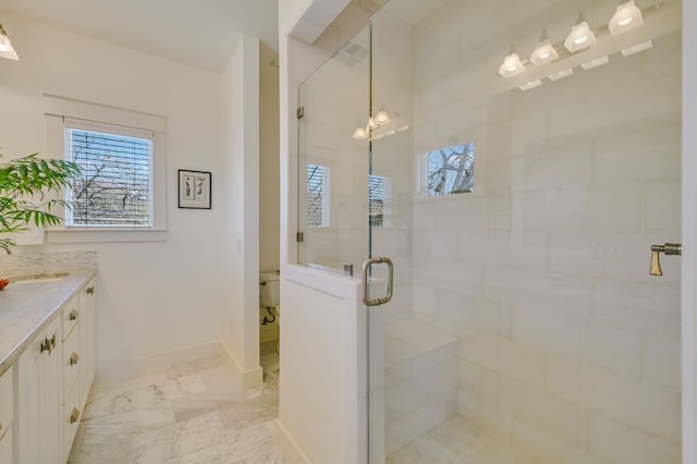 bathroom with vanity, a shower stall, baseboards, and marble finish floor