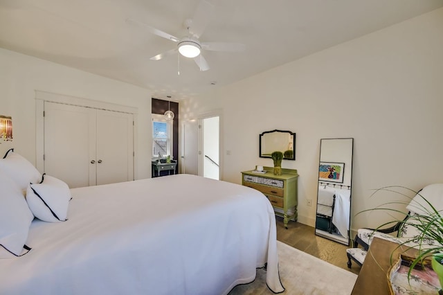 bedroom featuring a closet, a ceiling fan, and wood finished floors