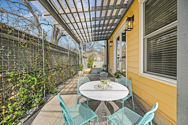 view of patio / terrace featuring outdoor dining space, a pergola, and a fenced backyard