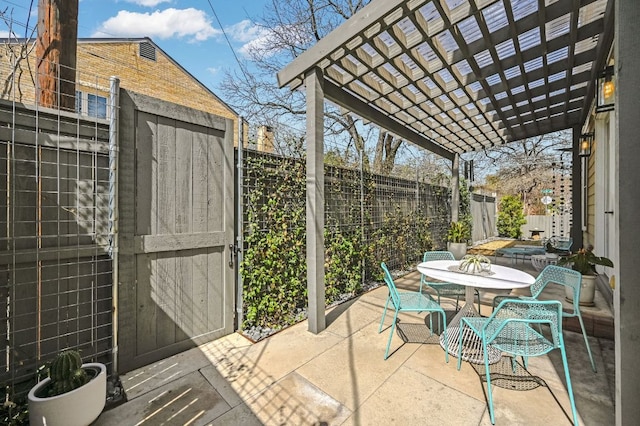 view of patio featuring a pergola, outdoor dining area, and a fenced backyard