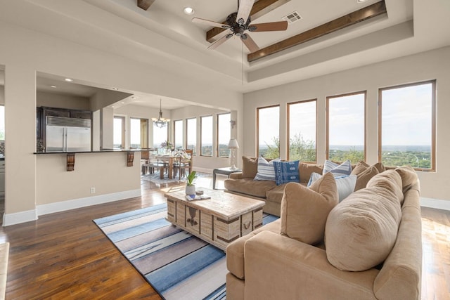 9104 Atwater Cv, Austin, TX 78733 - living area featuring baseboards, a raised ceiling, a chandelier, wood finished floors, and recessed lighting