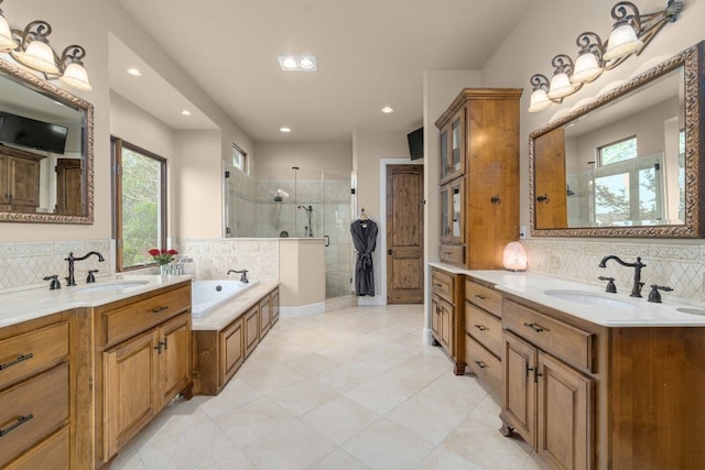 9104 Atwater Cv, Austin, TX 78733 - full bath with a shower stall, two vanities, healthy amount of natural light, and recessed lighting