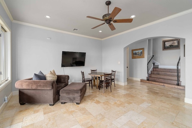 9104 Atwater Cv, Austin, TX 78733 - living room featuring arched walkways, a ceiling fan, stairway, baseboards, and stone tile floors