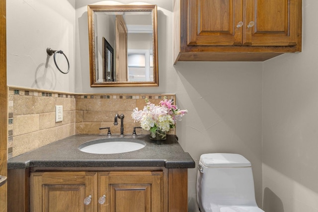 9104 Atwater Cv, Austin, TX 78733 - bathroom featuring vanity, toilet, and tasteful backsplash