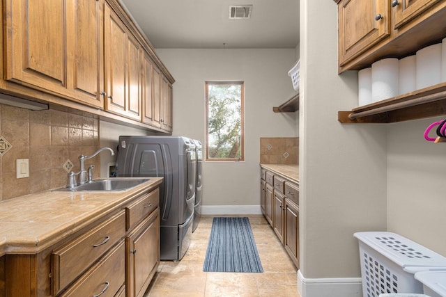 9104 Atwater Cv, Austin, TX 78733 - washroom with cabinet space, baseboards, independent washer and dryer, and light tile patterned floors
