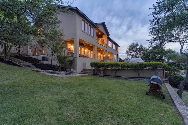 9104 Atwater Cv, Austin, TX 78733 - rear view of house with a lawn and stucco siding