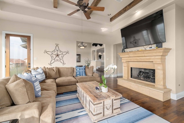 9104 Atwater Cv, Austin, TX 78733 - living area with hardwood / wood-style flooring, ceiling fan, a raised ceiling, a high end fireplace, and baseboards