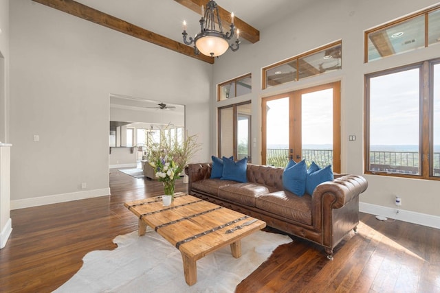 9104 Atwater Cv, Austin, TX 78733 - living room featuring healthy amount of natural light, hardwood / wood-style floors, baseboards, a towering ceiling, and beamed ceiling