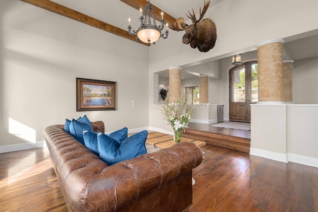 9104 Atwater Cv, Austin, TX 78733 - living area featuring decorative columns, wood finished floors, baseboards, and beamed ceiling