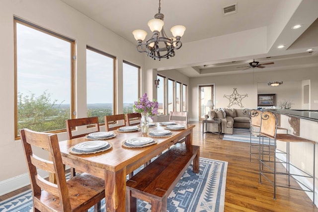 9104 Atwater Cv, Austin, TX 78733 - dining space with light wood-style floors, ceiling fan, baseboards, a chandelier, and recessed lighting