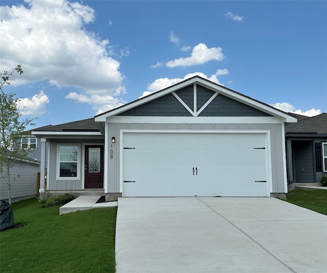 ranch-style home featuring board and batten siding, an attached garage, a front lawn, and concrete driveway