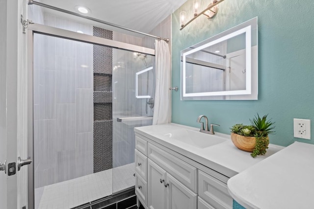 full bathroom featuring vanity and a tile shower