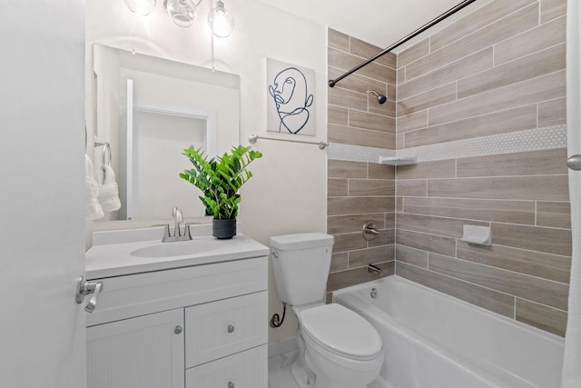 full bathroom featuring toilet, vanity, and washtub / shower combination