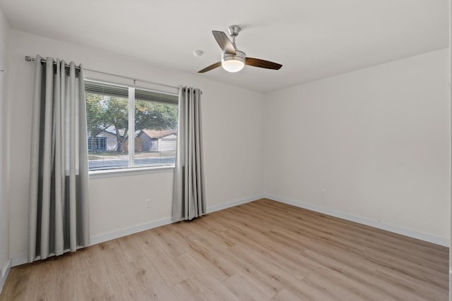 spare room with light wood-style flooring, baseboards, and ceiling fan