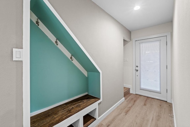 mudroom featuring baseboards and wood finished floors