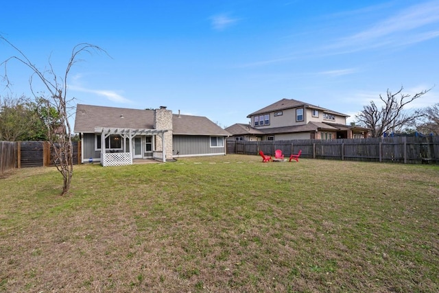 view of yard featuring a patio, a pergola, and a fenced backyard