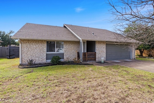 ranch-style house with driveway, an attached garage, roof with shingles, and a front lawn