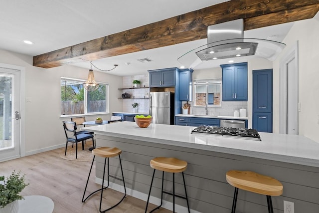 11216 Henge Dr, Austin, TX 78759 - kitchen featuring stainless steel appliances, blue cabinetry, a sink, open shelves, and a kitchen bar