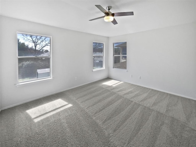 spare room featuring a ceiling fan, baseboards, and carpet floors