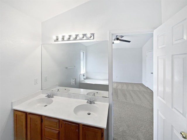 13449 Gent Dr, Austin, TX 78729 - bathroom with double vanity, a garden tub, and a ceiling fan