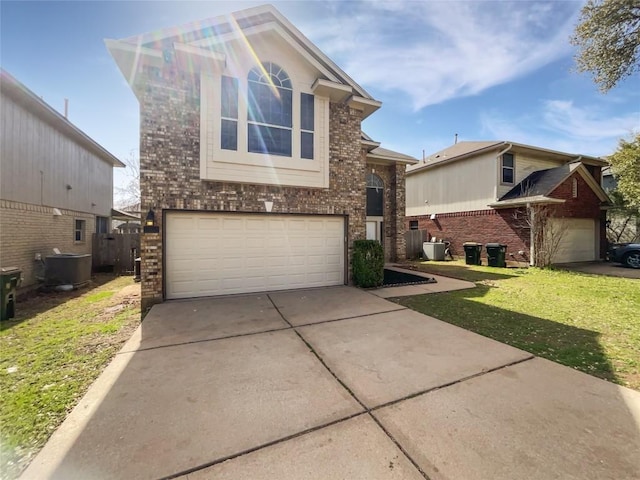 traditional home with brick siding, driveway, a front lawn, and a garage