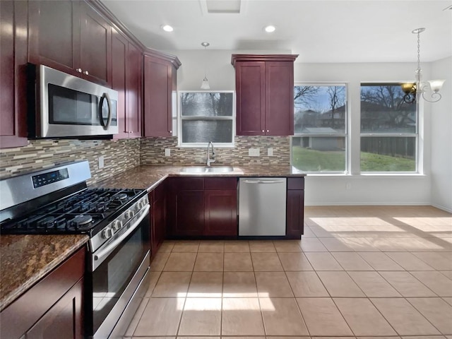 13449 Gent Dr, Austin, TX 78729 - kitchen with appliances with stainless steel finishes, a sink, dark brown cabinets, tasteful backsplash, and light tile patterned flooring