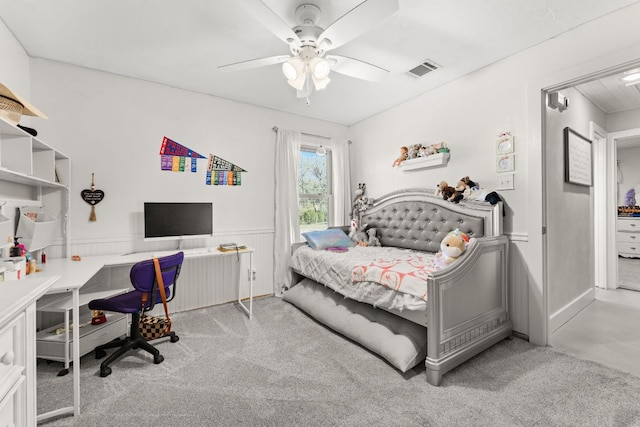 bedroom featuring visible vents, carpet flooring, ceiling fan, and wainscoting