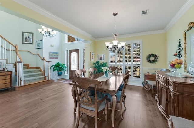 dining area with visible vents, a notable chandelier, dark wood finished floors, and stairs