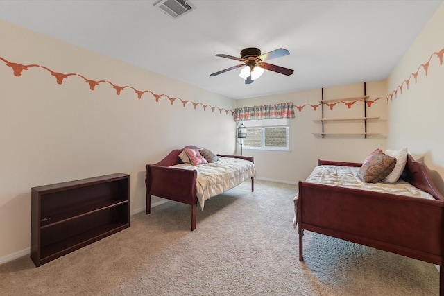 carpeted bedroom with visible vents, baseboards, and ceiling fan