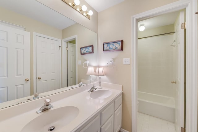 full bathroom featuring tile patterned flooring, double vanity, shower / bathtub combination, and a sink