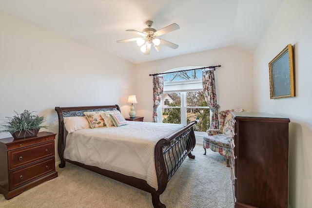 bedroom with a ceiling fan, vaulted ceiling, and light colored carpet