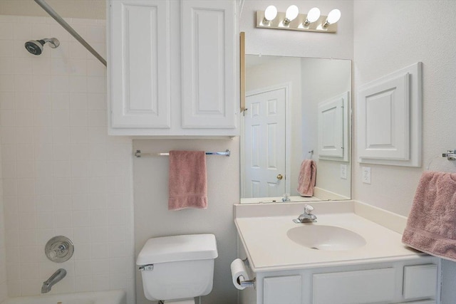 bathroom featuring vanity, shower / bathing tub combination, and toilet