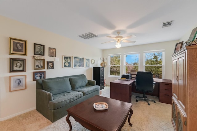 home office featuring ceiling fan, baseboards, visible vents, and light carpet