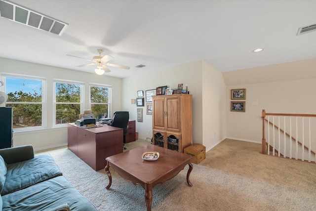 office space with visible vents, light carpet, and baseboards