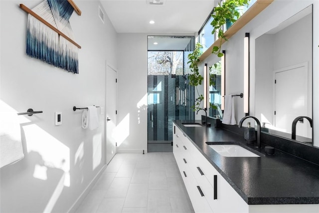 kitchen with a sink, visible vents, and dark countertops