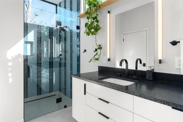 full bath with tile patterned floors, a shower stall, and vanity